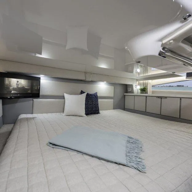 Slide: The Image of Luxurious interior cabin of 2022 Regal 33 XO yacht with modern bedding and decor. - 16
