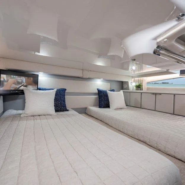 Slide: The Image of Interior of 2022 Regal 33 XO yacht with twin beds and modern decor. - 17