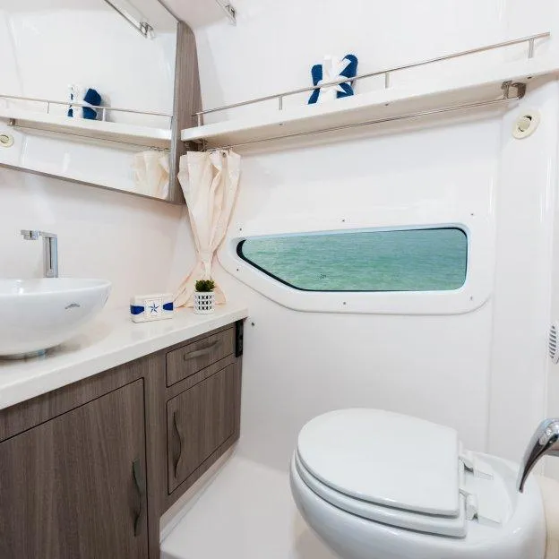 Slide: The Image of Luxurious bathroom interior of 2022 Regal 33 XO yacht with ocean view window. - 18