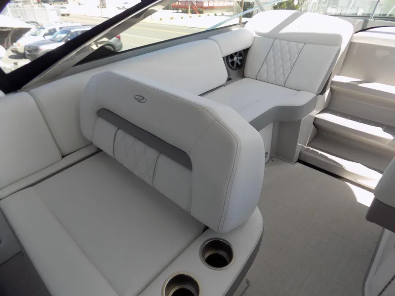 Slide: The Image of 2022 Regal 33 XO boat interior with white seating and cup holders. - 6