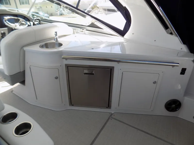 Slide: The Image of 2022 Regal 33 XO yacht interior with kitchenette and seating area. - 7