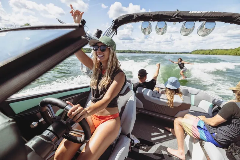 Slide: The Image of 2023 MasterCraft XT24 boat with people enjoying water sports. - 31