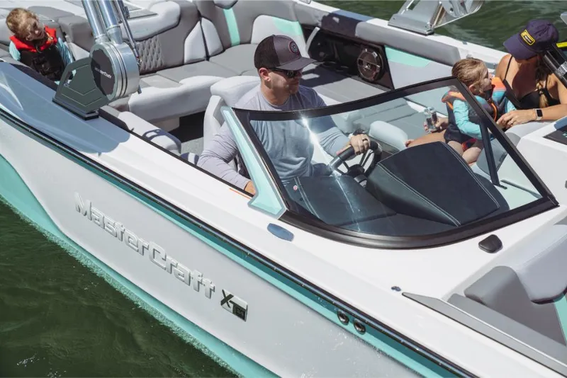 Slide: The Image of 2023 MasterCraft XT24 boat with family enjoying a day on the water. - 33