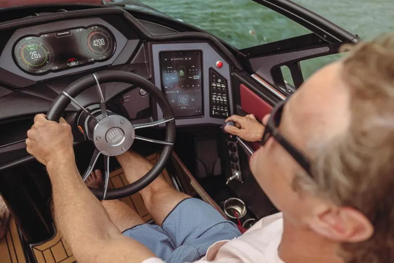 Slide: The Image of 2023 MasterCraft XStar S dashboard with advanced controls and touchscreen display. - 12