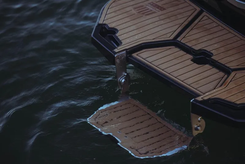 Slide: The Image of 2023 MasterCraft XStar S swim platform on water. - 16