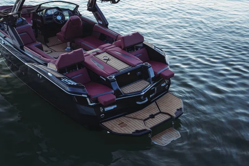 Slide: The Image of 2023 MasterCraft XStar S boat with luxurious seating on calm water. - 5