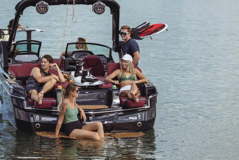 Slide: The Image of 2023 MasterCraft XStar S with friends relaxing on the lake. - 7