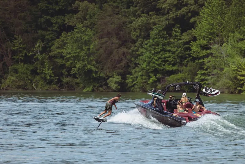Slide: The Image of 2023 MasterCraft XStar S towing a wakeboarder on a lake. - 8