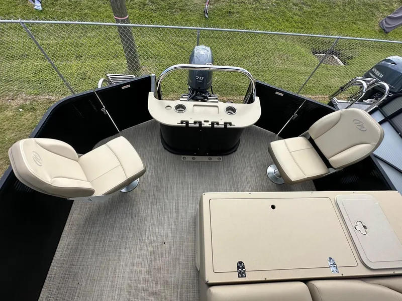 Slide: The Image of 2022 Manitou 20 Aurora Angler LE Standard boat interior with seating and control console. - 13