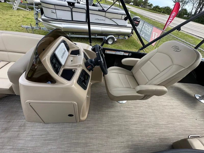 Slide: The Image of 2022 Manitou 20 Aurora Angler LE Standard boat interior with captain's chair and control console. - 16