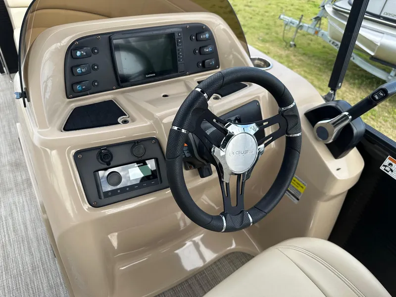 Slide: The Image of 2022 Manitou 20 Aurora Angler LE Standard boat dashboard with steering wheel and control panel. - 17