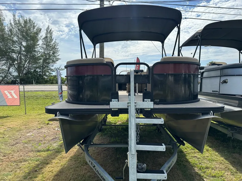 Slide: The Image of 2022 Manitou 20 Aurora Angler LE Standard pontoon boat on trailer. - 2