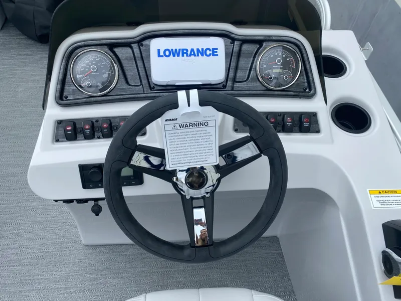 Slide: The Image of 2022 Godfrey Sweetwater 2186 C4 boat dashboard with Lowrance display and steering wheel. - 5