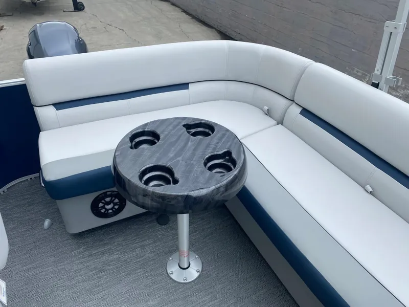 Slide: The Image of 2022 Godfrey Sweetwater 2186 C4 boat interior with cushioned seating and cup holder table. - 7