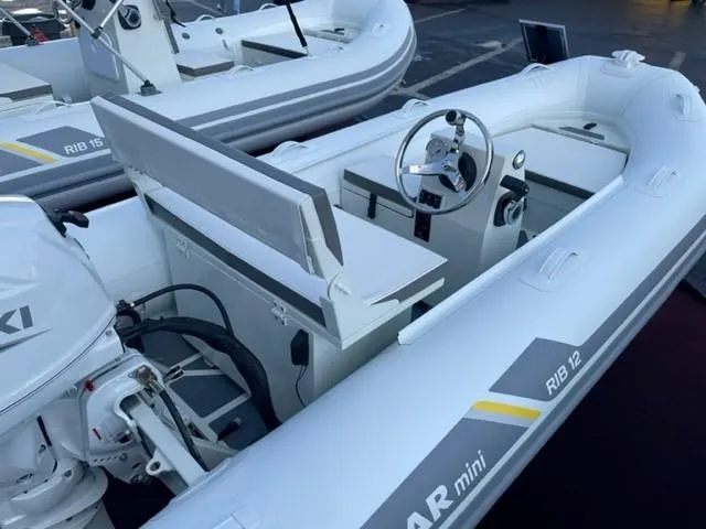 Slide: The Image of 2023 ZAR Mini RIB 12 T inflatable boat with Suzuki outboard motor. - 2