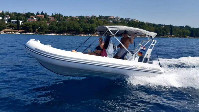 Slide: The Image of 2024 ZAR Mini RIB 16 inflatable boat cruising on blue water. - 1