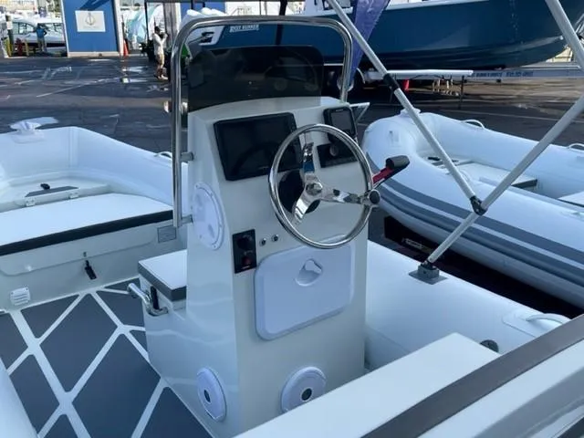 Slide: The Image of 2024 ZAR Mini RIB 16 boat interior with steering console and seating. - 3