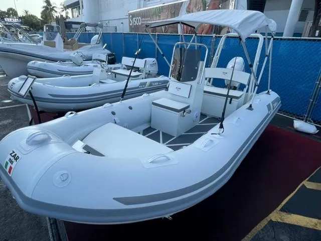 Slide: The Image of 2024 ZAR Mini RIB 16 inflatable boat with canopy, displayed outdoors. - 7