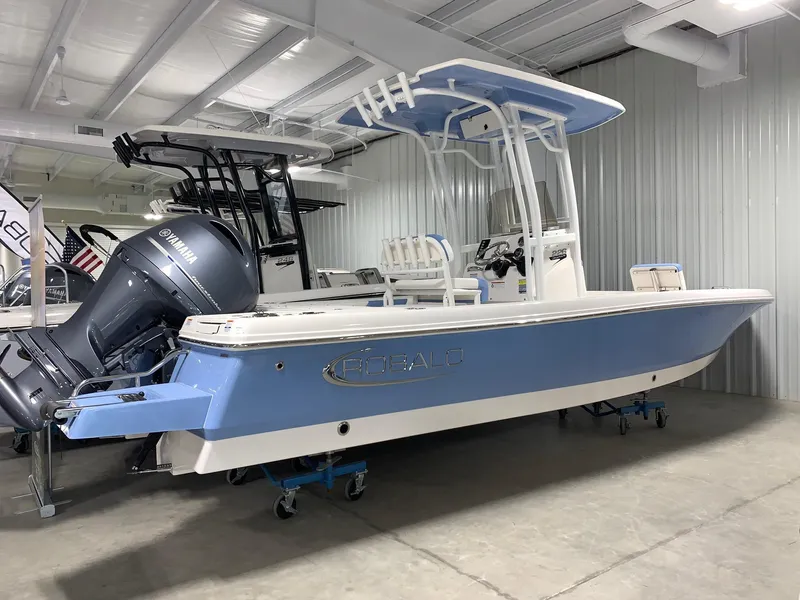 The Image of 2024 Robalo 226 Cayman boat in showroom, blue and white exterior. - 1