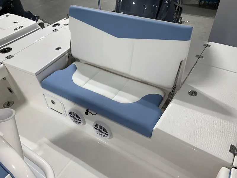 Slide: The Image of 2024 Robalo 226 Cayman boat with blue and white cushioned seating. - 10