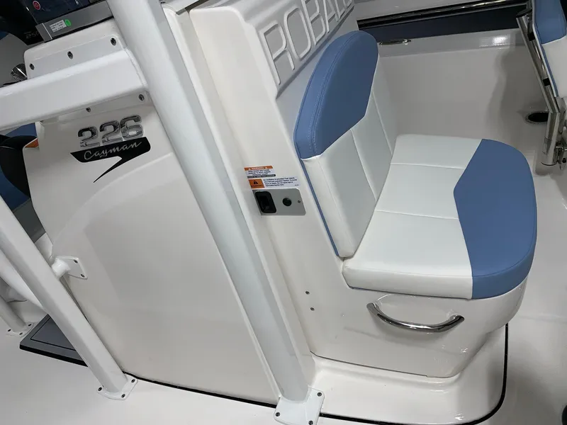 Slide: The Image of 2024 Robalo 226 Cayman boat interior with blue and white seating. - 13
