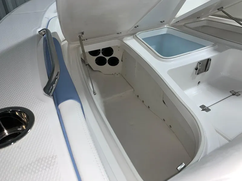 Slide: The Image of 2024 Robalo 226 Cayman boat storage compartment with open hatch. - 14
