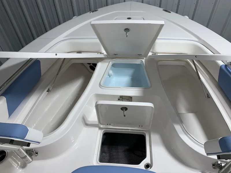 Slide: The Image of 2024 Robalo 226 Cayman boat storage compartments and seating. - 15