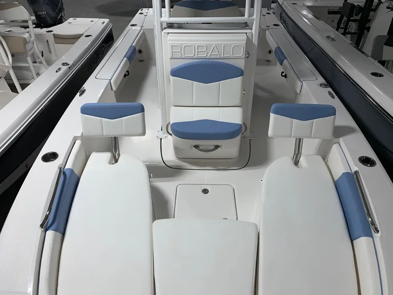 Slide: The Image of 2024 Robalo 226 Cayman boat interior with white and blue seating. - 3