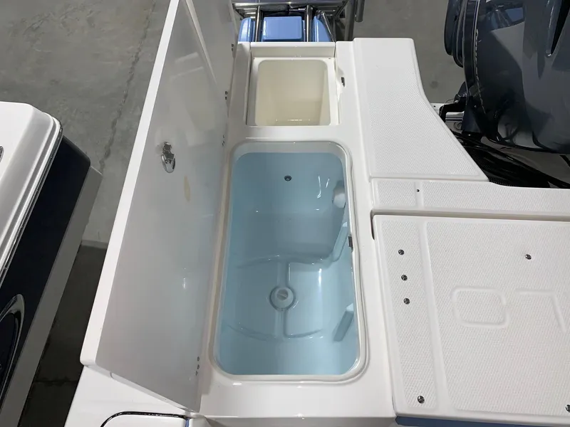Slide: The Image of 2024 Robalo 226 Cayman boat livewell and storage compartments. - 8