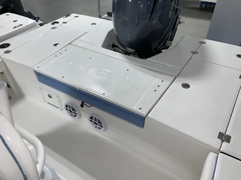 Slide: The Image of 2024 Robalo 226 Cayman boat stern with outboard motor and storage compartments. - 11