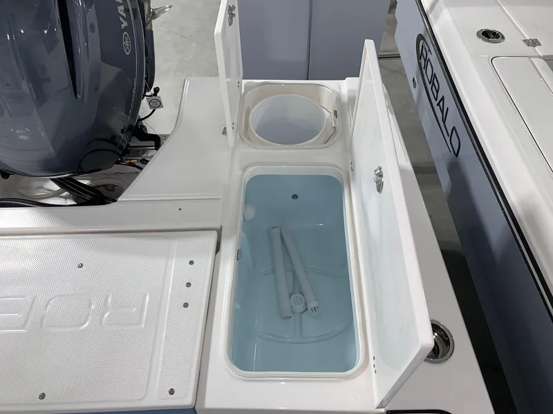 Slide: The Image of 2024 Robalo 226 Cayman boat with open storage compartments. - 9