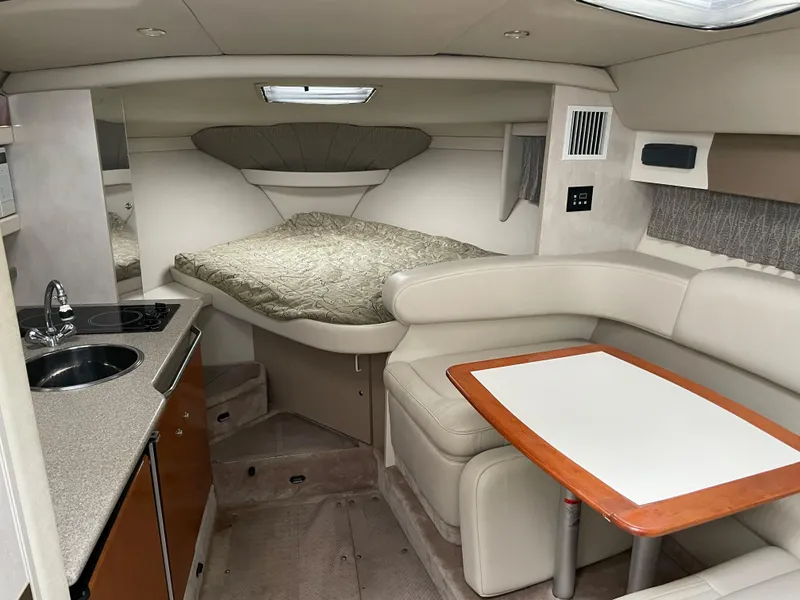 Slide: The Image of 2002 Formula 31 PC cabin interior with kitchenette, bed, and dining area. - 10