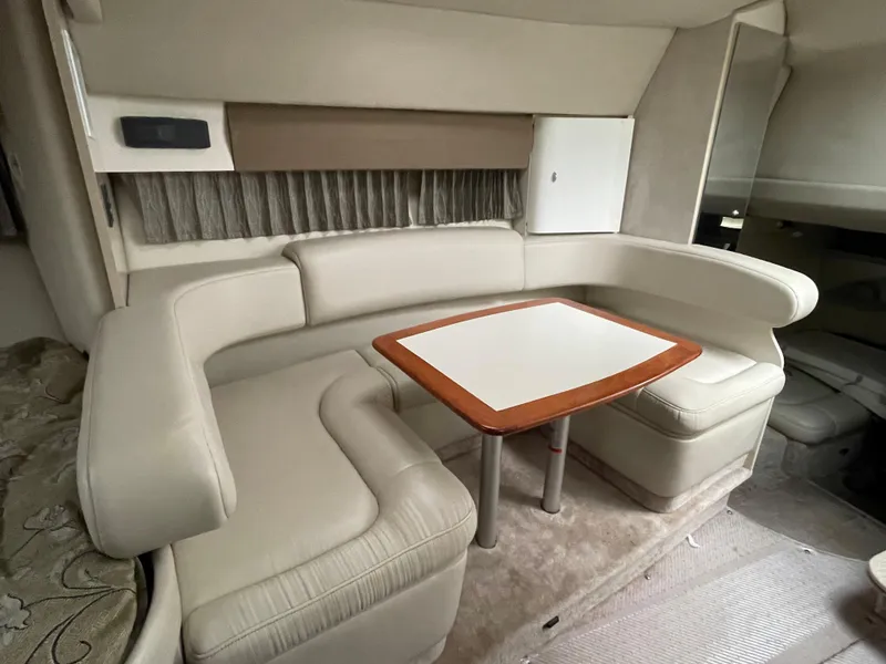 Slide: The Image of 2002 Formula 31 PC yacht interior with beige leather seating and wooden table. - 12