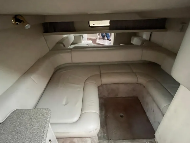 Slide: The Image of 2002 Formula 31 PC cabin interior with beige seating and a small window. - 14