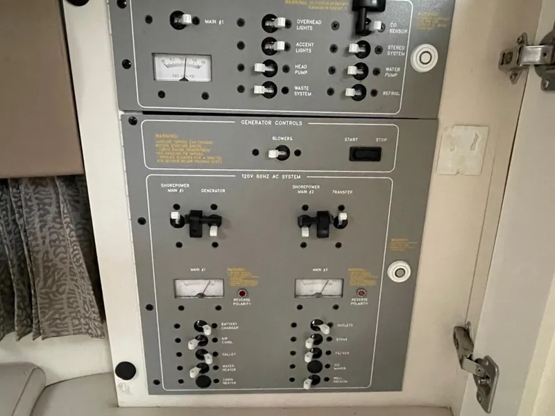 Slide: The Image of Control panel of a 2002 Formula 31 PC boat with various switches and gauges. - 16