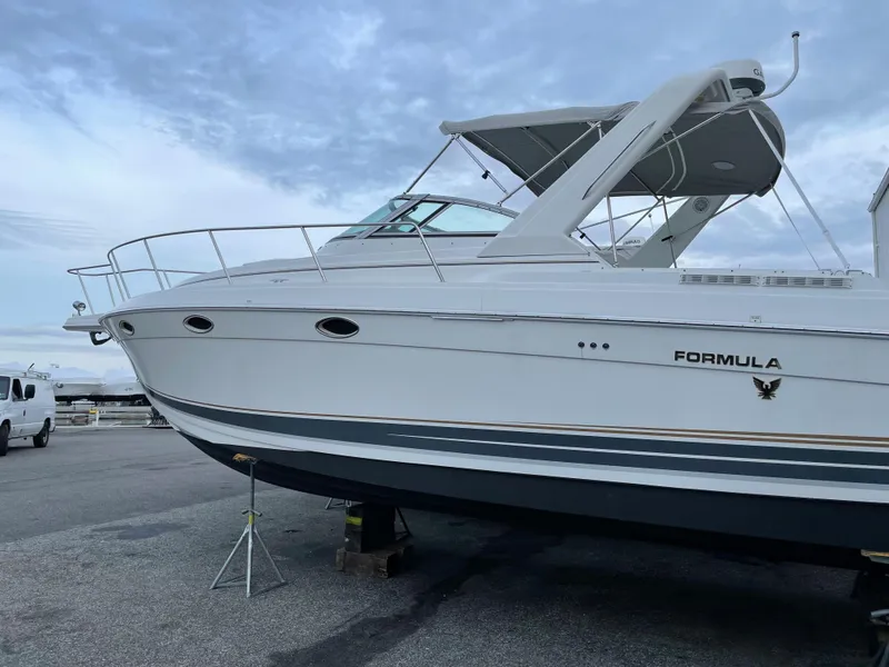 Slide: The Image of 2002 Formula 31 PC boat on dry dock with a blue sky background. - 2