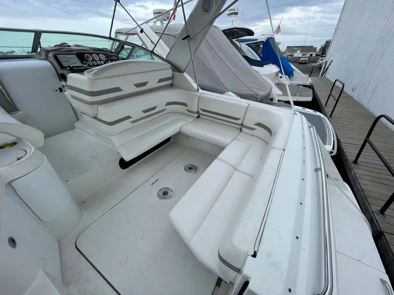 Slide: The Image of 2002 Formula 31 PC boat with spacious white seating area docked at marina. - 4