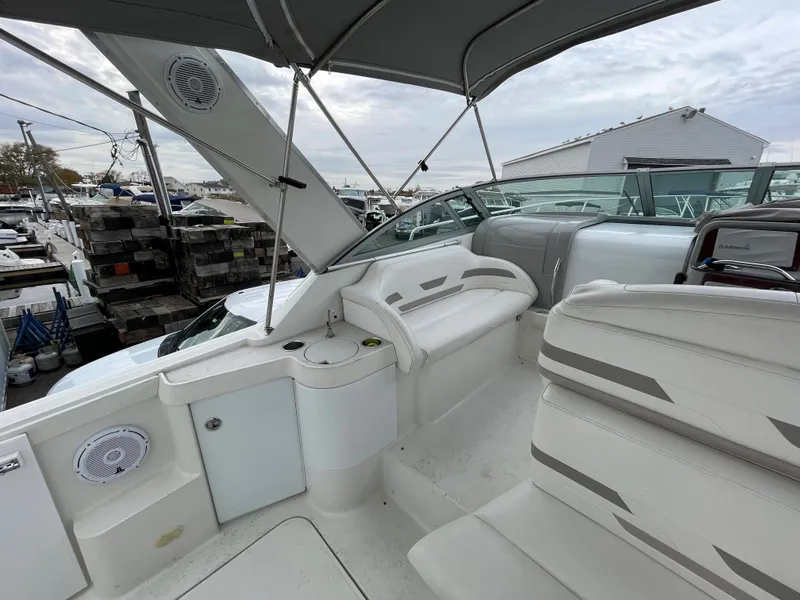 Slide: The Image of 2002 Formula 31 PC boat interior with white seating and canopy. - 6