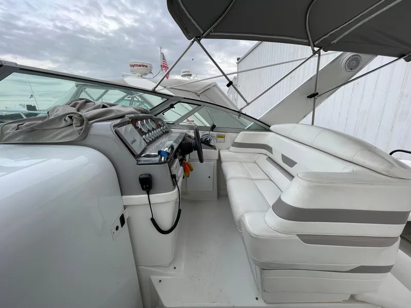 Slide: The Image of 2002 Formula 31 PC boat interior with white seating and control panel. - 7