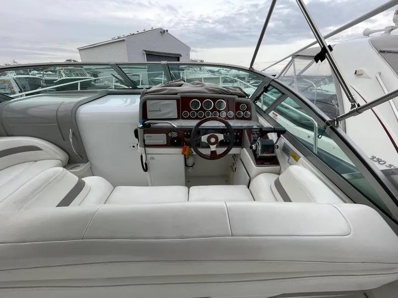 Slide: The Image of 2002 Formula 31 PC boat cockpit with white seating and control panel. - 8