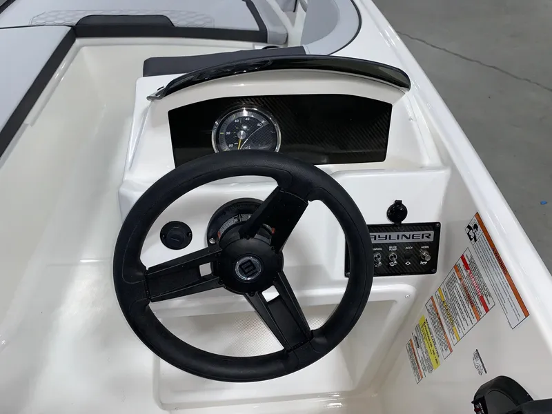 Slide: The Image of 2024 Bayliner Element M15 boat dashboard with steering wheel and control panel. - 5