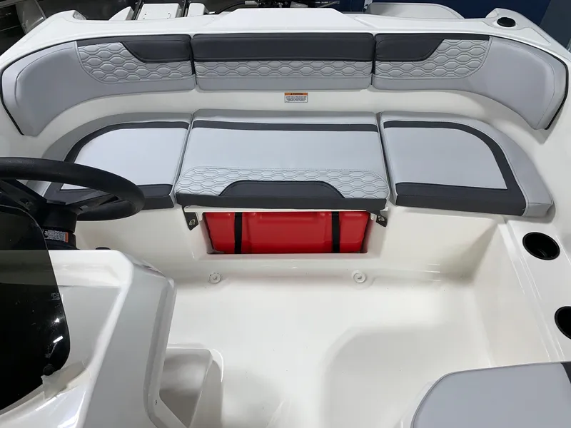 Slide: The Image of 2024 Bayliner Element M15 boat interior with cushioned seating and storage. - 8