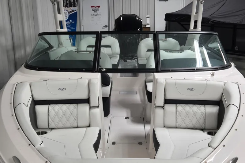 Slide: The Image of 2025 Regal LX2 boat interior with white leather seating and sleek design. - 2