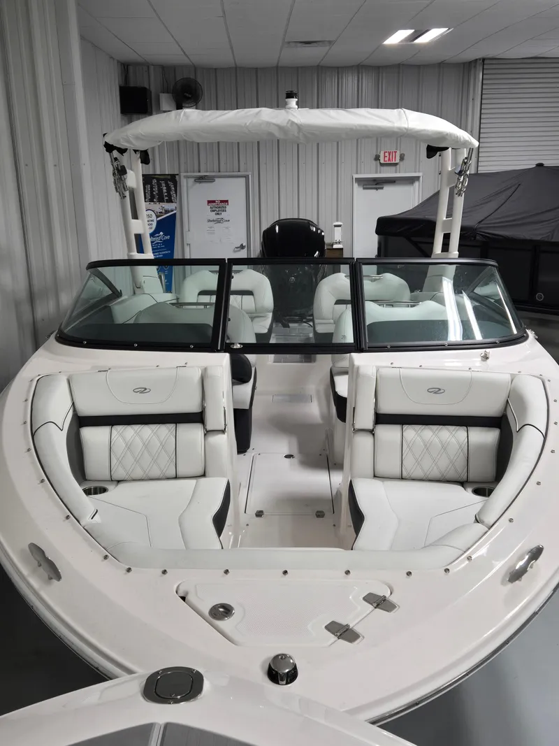 Slide: The Image of 2025 Regal LX2 boat with white interior, showcased in a showroom setting. - 7