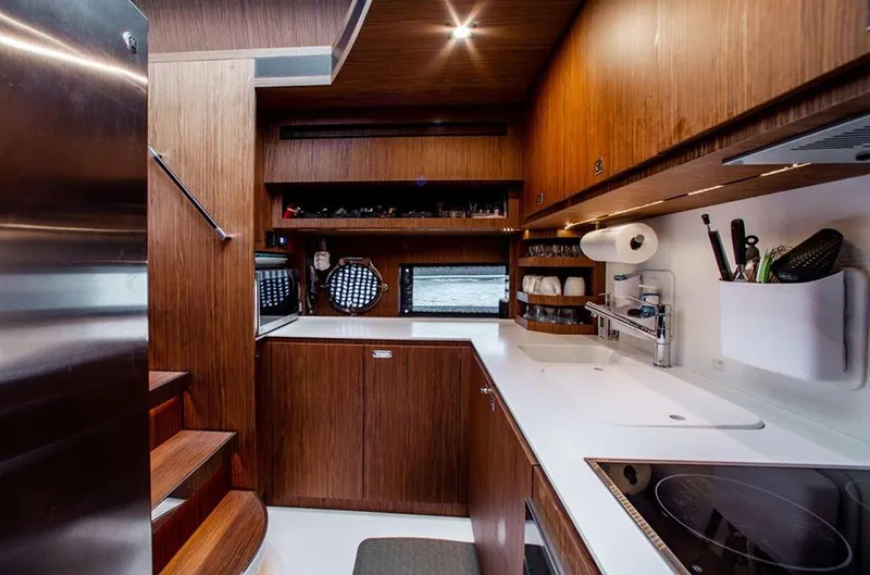 Slide: The Image of Modern kitchen interior of 2017 Riva 88 Domino Super yacht with wooden cabinetry. - 28