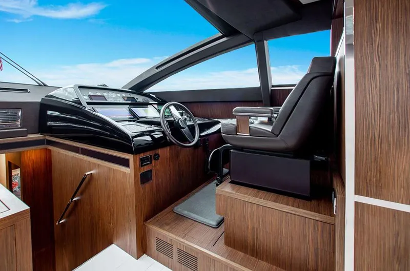 Slide: The Image of 2017 Riva 88 Domino Super yacht helm station with modern controls and luxurious seating. - 31