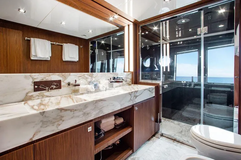 Slide: The Image of Luxurious bathroom on a 2017 Riva 88 Domino Super yacht with marble sink and ocean view. - 37