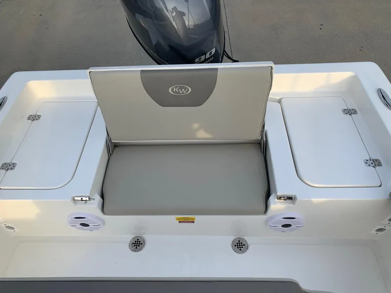 Slide: The Image of 2024 Key West 179 FS boat rear seating and storage compartments. - 11
