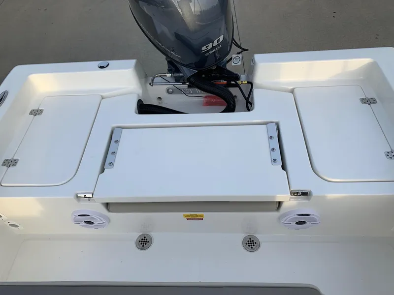 Slide: The Image of 2024 Key West 179 FS boat stern with storage compartments and outboard motor. - 12