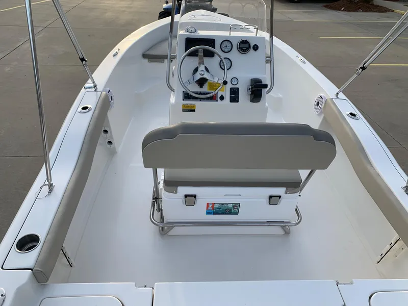 Slide: The Image of 2024 Key West 179 FS boat interior with steering console and seating. - 15